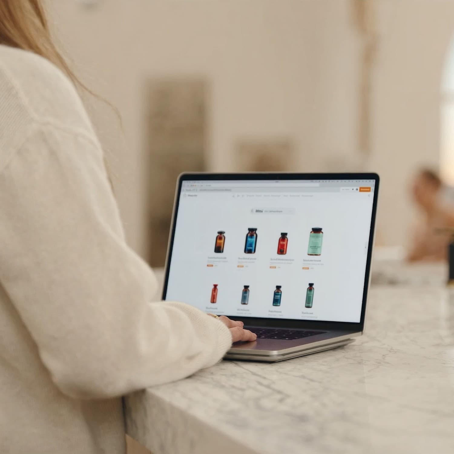 Someone viewing a supplement on a laptop at a kitchen counter