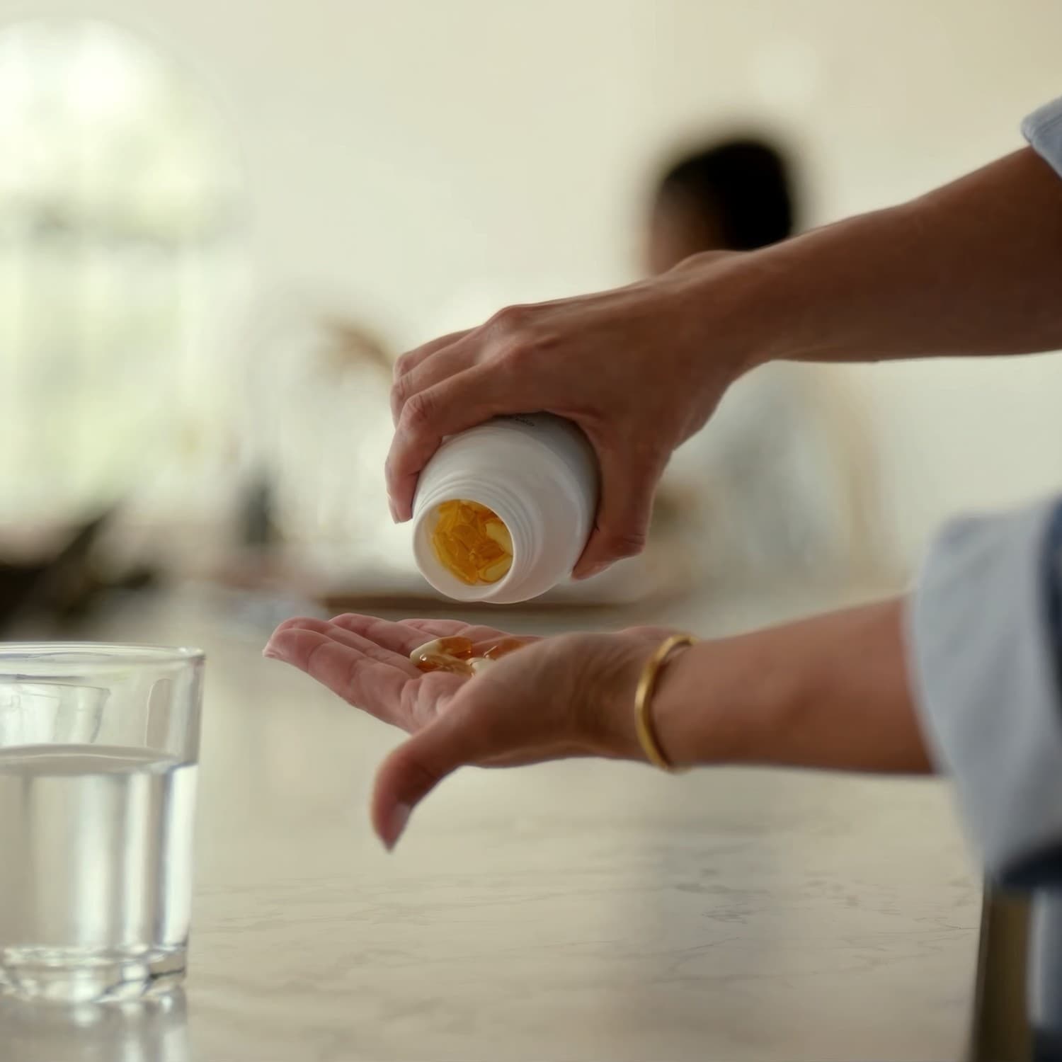Golden softgel supplement capsules on a white surface